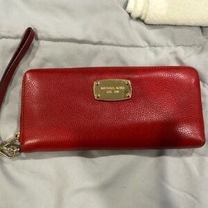 Red pebbled leather MK (Michael Kors) zip around wallet w/ wrist strap. GUC